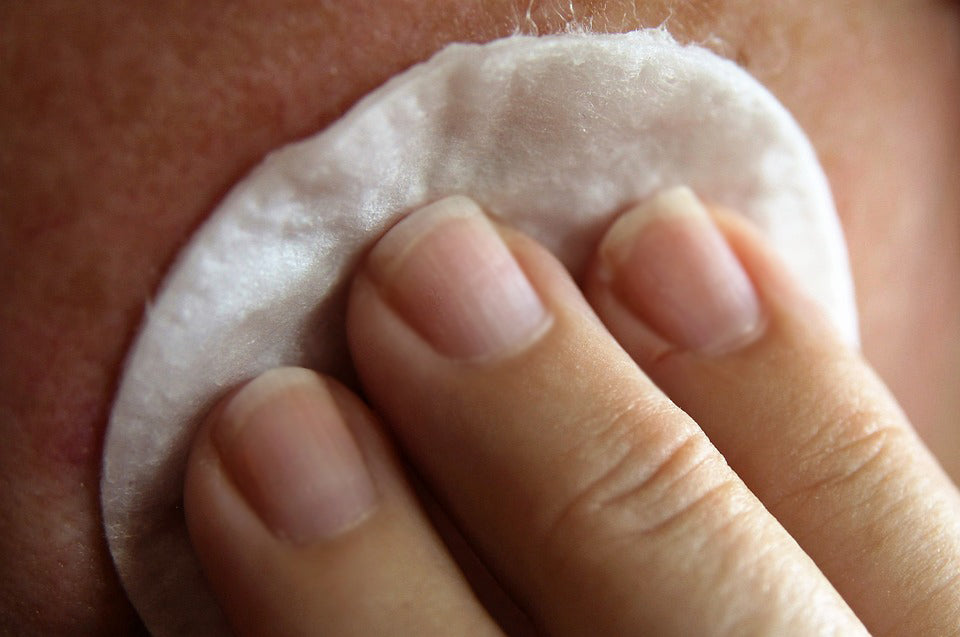 Natural Toner: Cotton pad being applied to skin